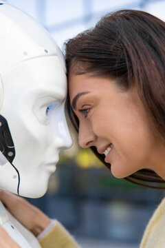 Vertical close-up of happy woman touching forehead with android