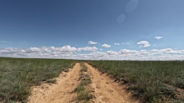 Forward movement along dirt road in grassland