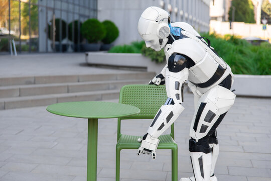 White cybernetic robot positioning terrace chair