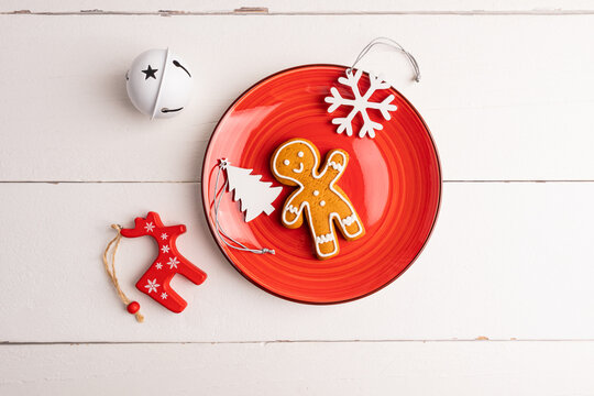 Christmas gingerbread cookie on red plate with rustic decor