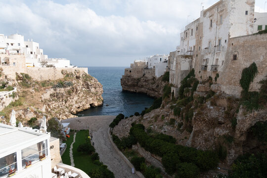 high angle view of the famous lama monachile beach, cala porto. in the historic center of polignano a mare, apulia, southern italy.