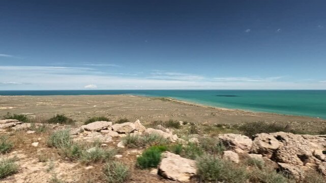 Forward movement overlooking a coastal desert plain and sea