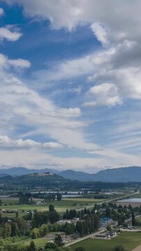 Stunning Time-Lapse View of Chilliwack in Fraser Valley, British Columbia, with Majestic Mountains and Dynamic Clouds