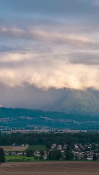 Panoramic View of Chilliwack's Fraser Valley with Majestic Mountains and Rolling Clouds in British Columbia