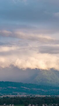 Dramatic Clouds Gracefully Move Over Lush Green Mountains and the Fraser Valley in Chilliwack, British Columbia, Canada