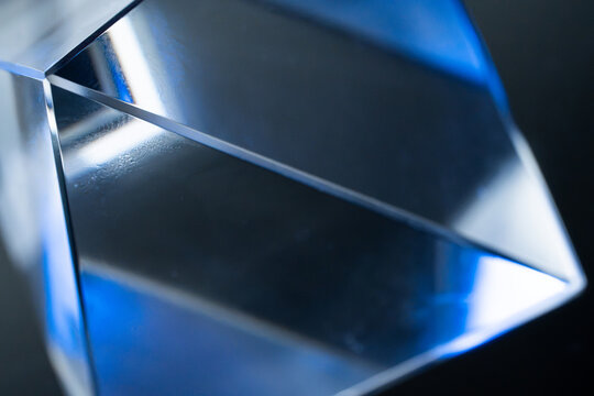 Abstract blue crystal prism with reflective geometric facets