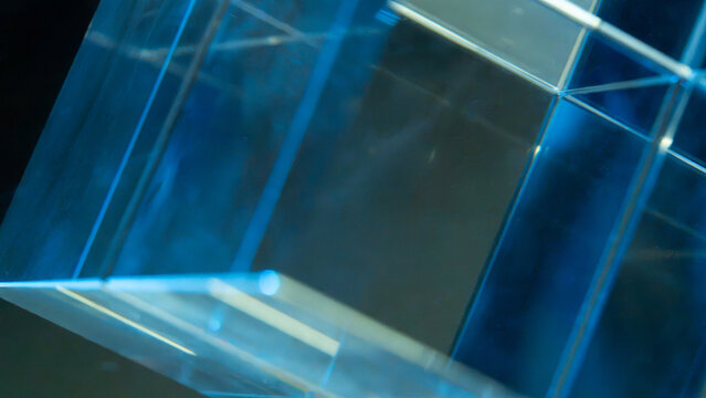 Abstract blue glass prism with reflective geometric light