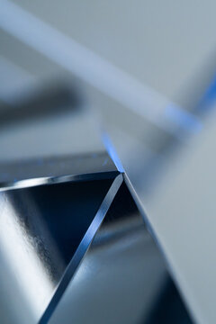 Abstract close-up of polished stainless steel geometric surface