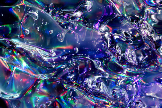 Iridescent liquid texture with bubbles and colorful reflections