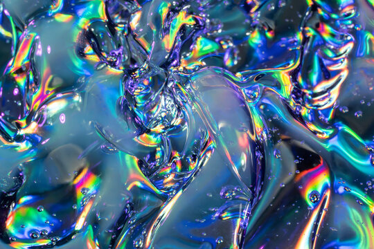 Iridescent liquid metal texture with rainbow reflections
