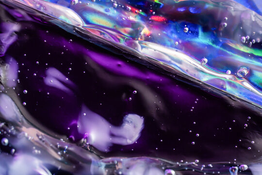Iridescent liquid texture with purple bubble abstract background