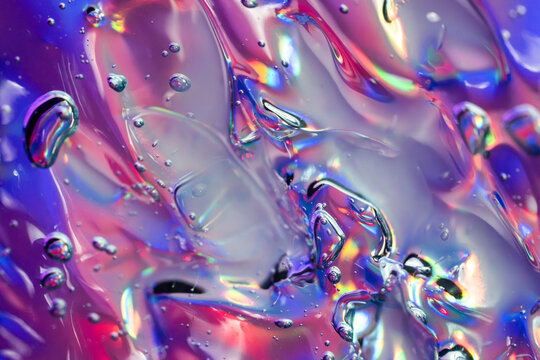 Iridescent liquid texture with colorful bubbles and reflections