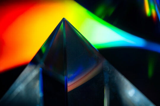 Futuristic glass prism refracting colorful spectrum light