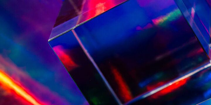 Futuristic glass cube with neon light reflections background