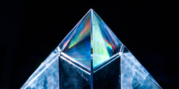 Futuristic crystal pyramid with rainbow prism refraction