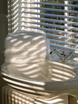 Stack of clean white towels in modern bathroom