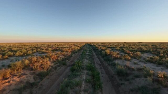 Moving Forward Along A Dirt Road In Flat Landscape