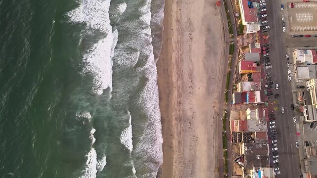Aerial drone view of Playas de Tijuana coastline and Pacific Ocean waves in Baja California Mexico