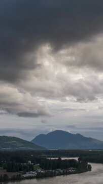 Panoramic View of the Fraser River and Mountains in Chilliwack, British Columbia Under Dramatic Clouds
