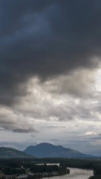 Dramatic Cloudscape Over Chilliwack's Fraser River and Majestic Mountains in British Columbia, Canada