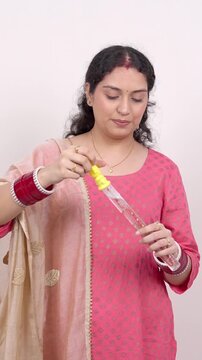 Vertical Shot of Playful Married Indian Woman Blowing Soap Bubbles &ndash; Carefree Lifestyle Concept