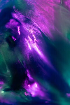 Abstract purple and teal fluid texture with luminous glow