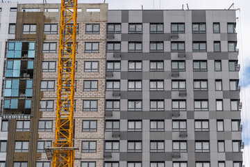 Construction site showcases modern building transformation against blue sky © beholdereye