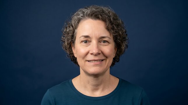 Portrait of a smiling middle-aged woman with curly gray hair on a