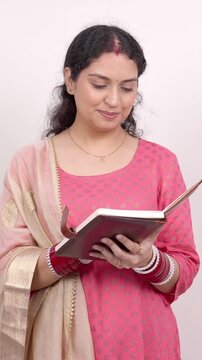 Vertical Shot of Happy Married Indian Woman Opening and Reading a Diary