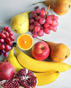 Fresh fruits mixed. Tasty fruits background, citruses, apples, grapes.