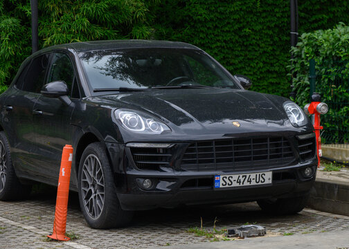 August 15, 2026, Tbilisi, Georgia Editorial stock photography of a black Porsche Macan SUV parked in an urban parking lot