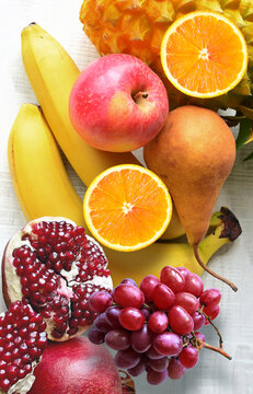 Fresh fruits mixed. Tasty fruits background, citruses, apples, grapes.