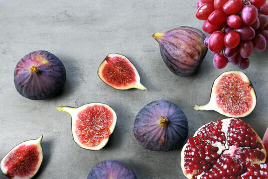 Fresh fruits mixed. Tasty fruits background, fig, grapes, pomegranate.