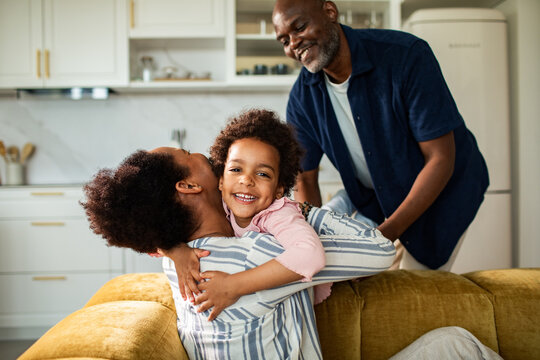 Happy family hugging at home in kitchen
