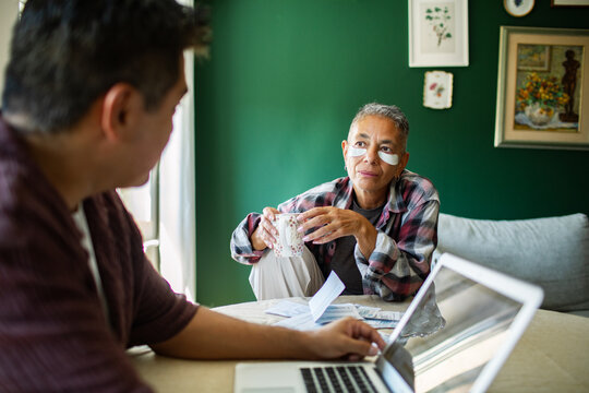 Mature woman with eye patches discussing household finances at home