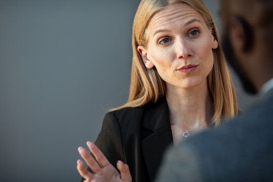 Professional businesswoman gesturing stop during workplace discussion