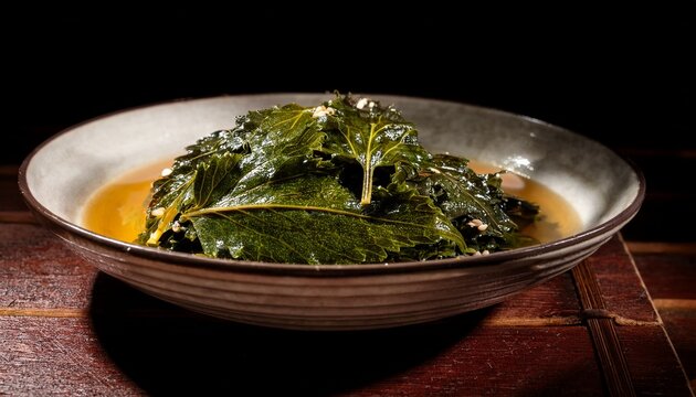a single aged banchan dish holding pungent marinated perilla leaves kkaennip jangajji under focused light