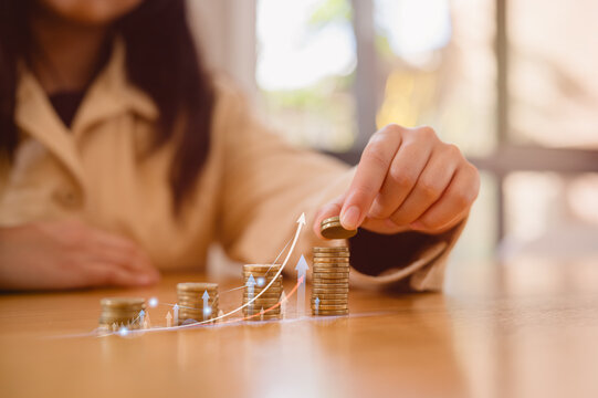 Saving money concept. Young girl's hand put coin on coins stack. Financial growth, investment, wealth management, budgeting, economic planning and longterm stability for personal finance success.