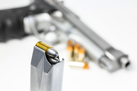 bullet 9mm  parabellum LRN ( lead round nose )  in magazines and 9mm postal gun in background.