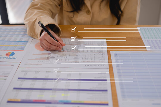 Close up young businesswoman hands writing pen on paper. hands writing planing meeting agenda on wooden table. Close up hand write using pen note Personal Organizer sign contrac