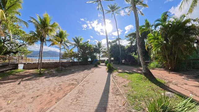 First Person Walking Along a Tropical Path to Feiticeira Beach in Ilhabela, Brazil