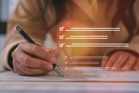 Close up young businesswoman hands writing pen on paper. hands writing planing meeting agenda on wooden table. Close up hand write using pen note Personal Organizer sign contrac