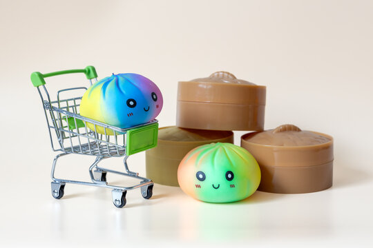 Colorful dumpling shaped squishy toys with miniature shopping cart and plastic steamer baskets
