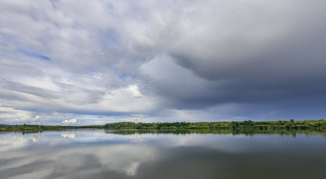 Serene lake with storm clouds mirrored below