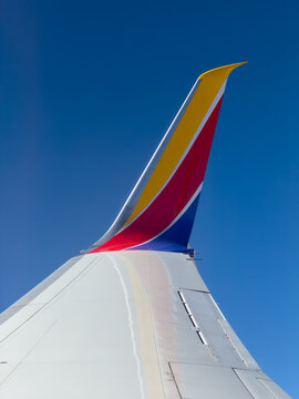 BURBANK, CA, APR 28, 2026: Close-up upward shot of a Southwest Airlines winglet against a deep blue clear sky, showing the wing's curved tip design