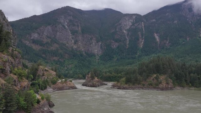 Majestic River Flowing Through Lush Forests and Towering Mountains in British Columbia, Canada