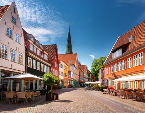 historic street scene in husum s old town with restaurants cafes cobblestone streets and colorful buildings on a sunny summer day