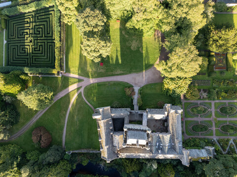 Direct top-down vertical aerial photographl Cawdor Castle featuring its stone roofs, hedge maze, manicured lawns, and ornamental gardens in Nairnshire, Scottish Highlands