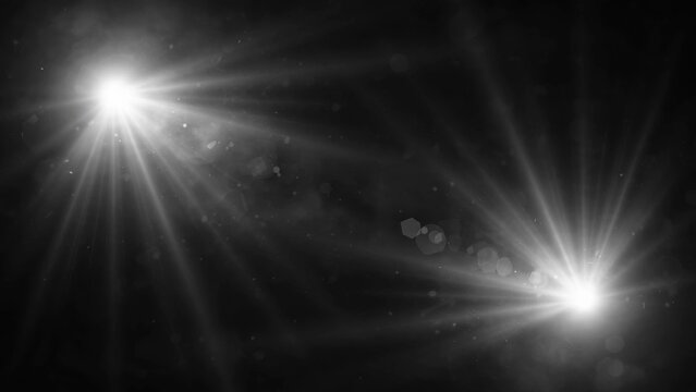 Two bright lens flares with starbursts and bokeh against a dark, smoky background