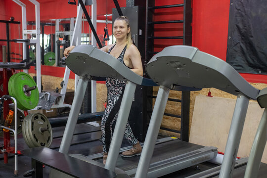 A woman with cerebral palsy walks on a treadmill. 